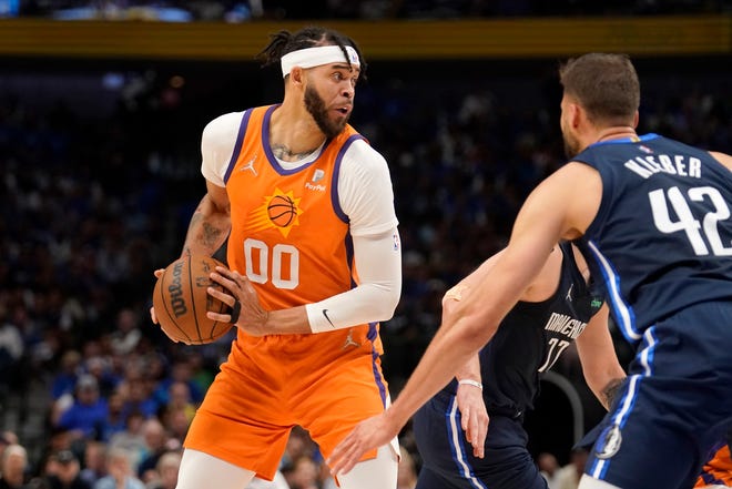 Phoenix Suns center JaVale McGee (00) works to pass the ball as Dallas Mavericks forward Maxi Kleber (42) defends in the first half of Game 4 of an NBA basketball second-round playoff series, Sunday, May 8, 2022, in Dallas.
