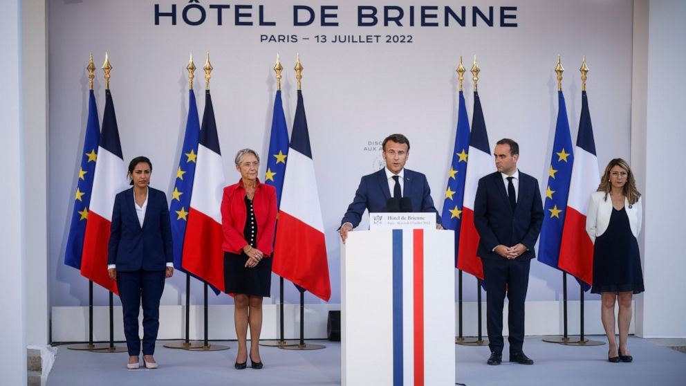 French President Emmanuel Macron, center, flanked by Defense Minister Sebastien Lecornu, second right, and Prime Minister Elisabeth Borne, second left, delivers his speech to militaries on the eve of Bastille Day, Wednesday, July 13, 2022 at the Defe