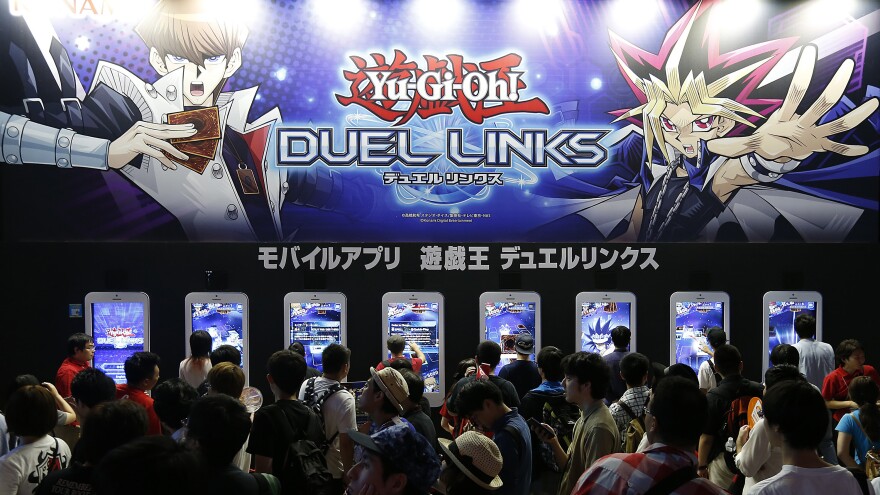 Visitors play Yu-Gi-Oh! Duel Links at the Tokyo Game Show in 2016 in Chiba, Japan.